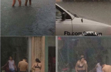 Cô gái diện bikini lội nước mưa giữa phố