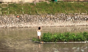 Cô gái hồn nhiên mặc nội y bơi giữa sông Tô Lịch lại tạo dáng bên bè trồng hoa khiến giao thông tắc nghẽn