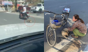 Người đàn ông phóng xe máy rồi cầm dây kéo lê chú chó hàng trăm mét trên đường