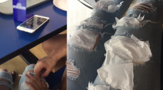 Chàng trai lấy giấy lấp vào chỗ thủng trên quần bạn gái giữa quán ăn