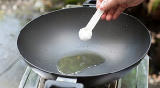 Vì sao khi chiên rán người ta thường thả vài hạt muối vào chảo dầu?